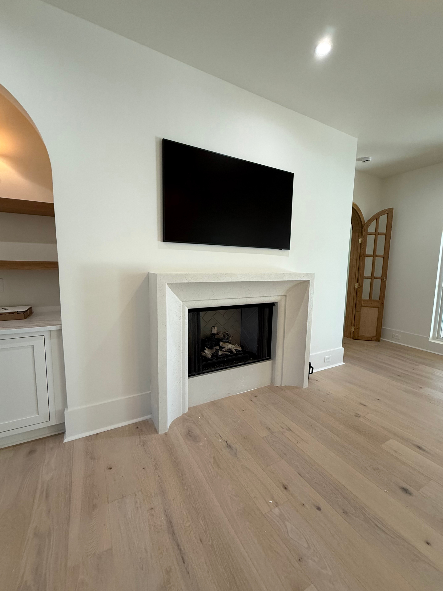 75-inch TV mounted above fireplace in Cumming, GA with MantelMount and hidden cables
