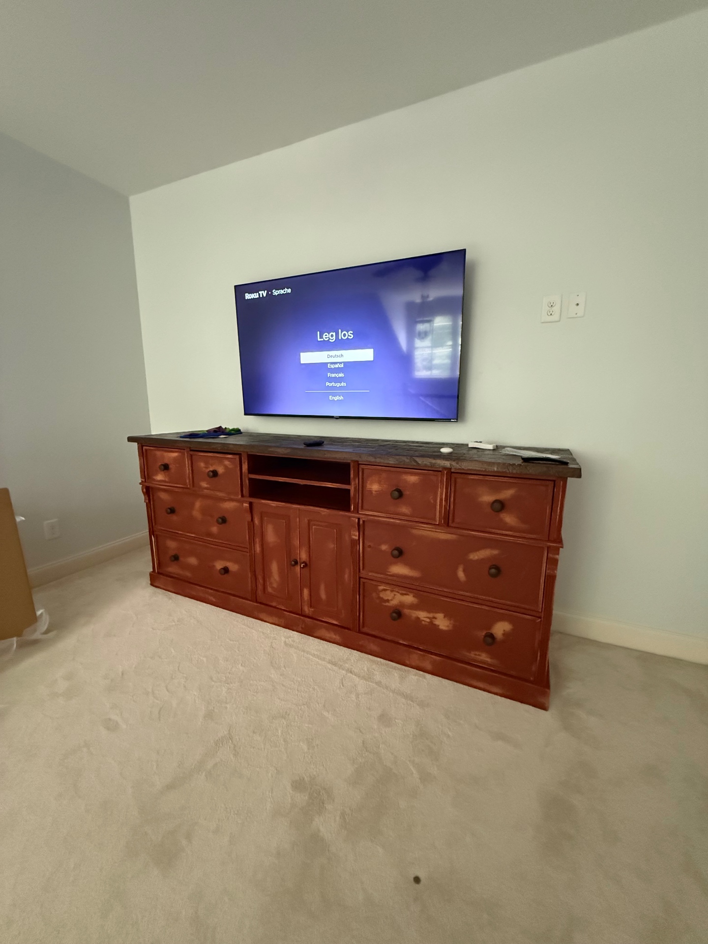 65-inch TV mounted on drywall in Hiram, GA entertainment room with tilt mount and new recessed outlet installed behind the TV