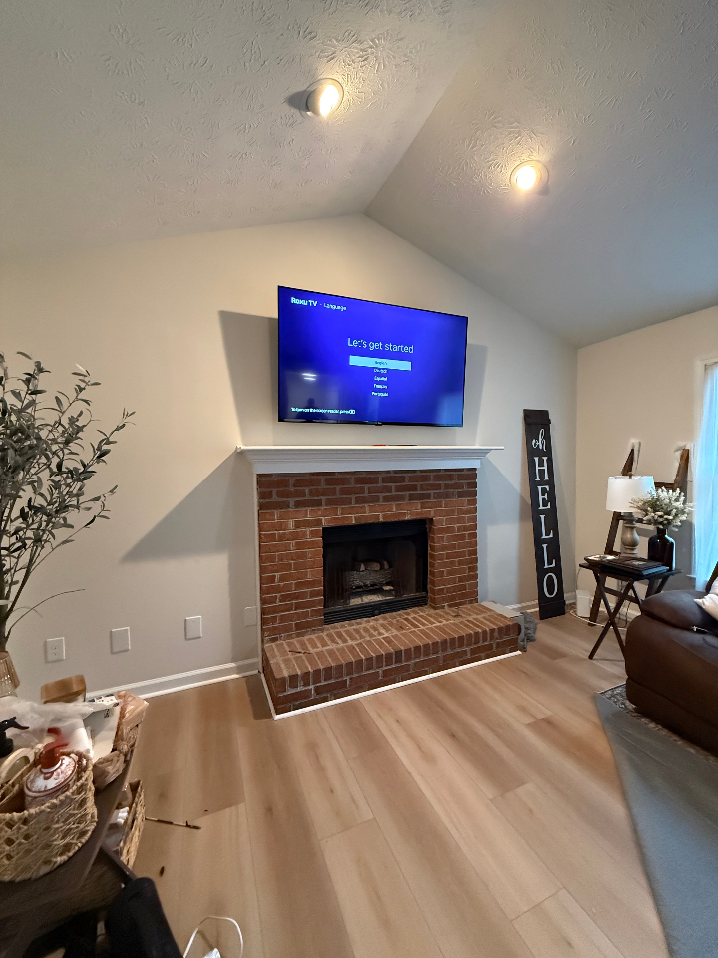 65-inch TV mounted over brick fireplace mantel in Lawrenceville, GA
