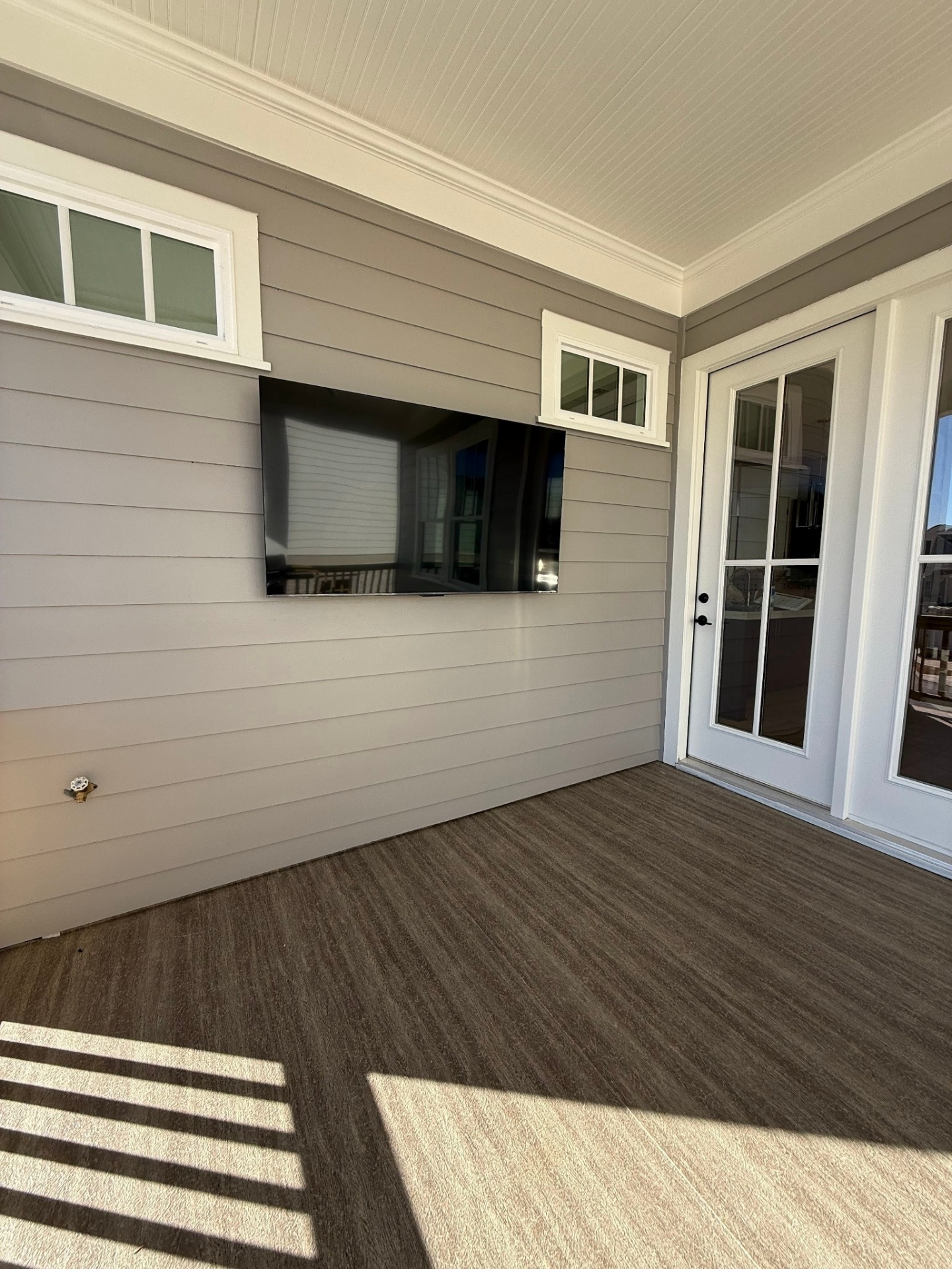 Outdoor TV mounted on covered porch with weather-rated bracket in Dunwoody, GA
