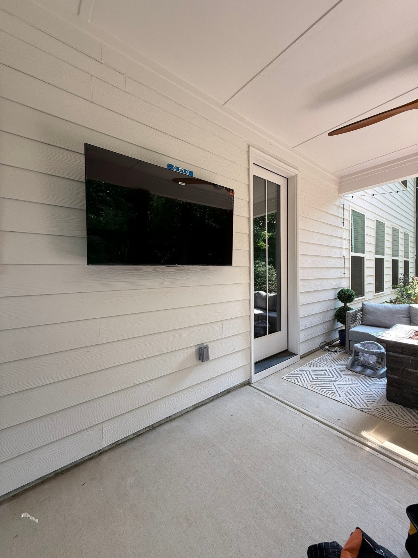 TV mounted in covered patio lounge area in Cartersville, GA with outdoor-rated mount