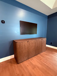 65-inch TV mounted on drywall in Roswell, GA master bedroom with wire concealment